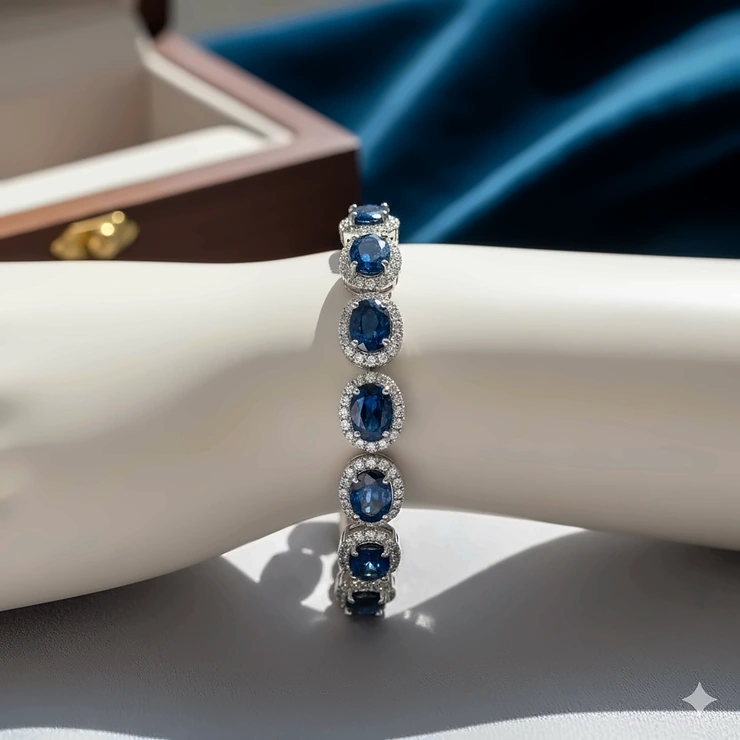 Elegant sapphire and diamond bracelet in a halo setting on a mannequin's wrist, showcasing its timeless beauty.