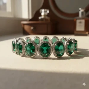Detailed shot of an oval cut emerald bracelet, emphasizing the clarity and cut of the gemstones.