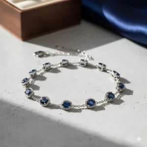 Overhead view of a delicate station-style bracelet featuring oval-cut sapphire and diamond accents.