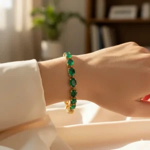 Model wearing a natural emerald bracelet elegantly on her wrist, showing how the jewelry drapes.