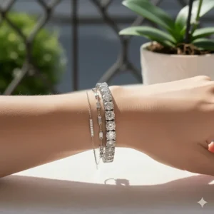 Example of stacking different designs of silver diamond bracelets for a layered look.