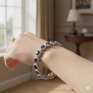 A woman's wrist adorned with a sparkling sapphire tennis bracelet and diamond accents.