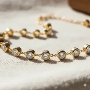 Macro closeup of a round brilliant diamond in a bezel setting on a gold diamonds by the yard bracelet.