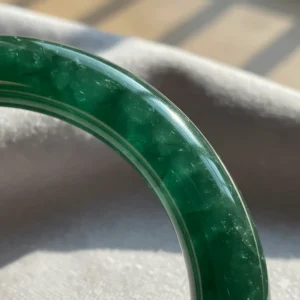 Macro shot highlighting the smooth, translucent texture and natural clarity of a high-quality jade bangle bracelet.