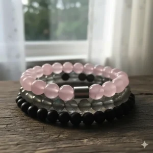 A stylish stack of rose quartz and other compatible gemstone bracelets for men, showing layering options.