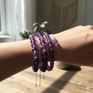 Image showing a stylish way to stack multiple amethyst bracelets in a complementary set.