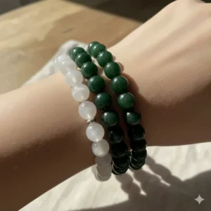 Stylish image of two different jade bead bracelets stacked together to achieve a trendy layered jewelry look.