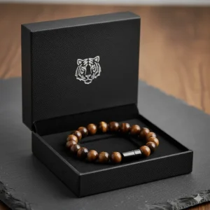 An unwrapped tiger eye bracelet resting in its premium black velvet gift box, ready for presentation.
