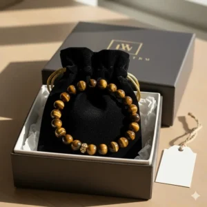 The handmade tiger eye bracelet resting inside a branded velvet pouch and ready for gifting.
