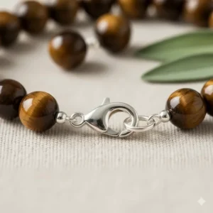 View of the durable tiger eye bracelet closure, featuring a secure sterling silver lobster clasp.