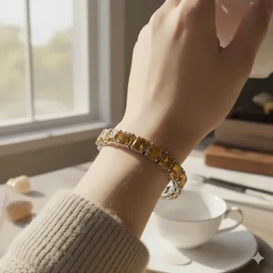 Close-up of a stylish citrine tennis bracelet being worn on a woman's wrist, complementing her elegant attire.