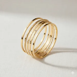 A complete 5-piece stackable gold bangles set displayed against a neutral background.