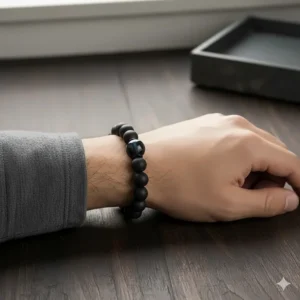 Stylish shot of the black agate bracelet for men being worn on a male wrist, demonstrating comfortable fit and masculine style.