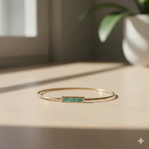 Minimalist thin gold bar bracelet featuring a small inlaid turquoise stone.