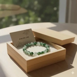 A moss agate bracelet presented in a sustainable wooden gift box with a jewelry care card.