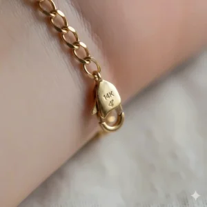 Close-up illustration of the 14k gold hallmark stamp on a women's chain bracelet clasp.