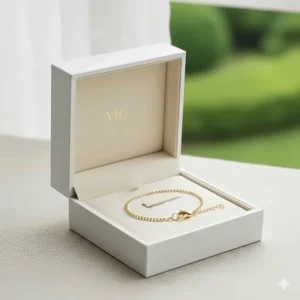 Illustration of a luxury jewelry gift box containing a shimmering 14k gold chain bracelet for women.