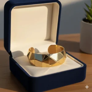 A geometric gold cuff bracelet presented inside a luxury velvet jewelry box.