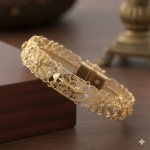 Detailed view of a handmade gold bridal bracelet featuring intricate filigree patterns and a secure clasp.