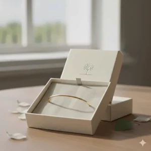 A thin minimalist cuff bracelet inside a sustainable premium jewelry gift box.