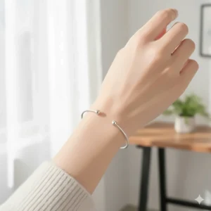 A simple, thin silver wire adjustable cuff bracelet for women, perfect for everyday wear.