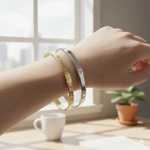 Three different styles of silver hinged bangle bracelets with clasps layered together.