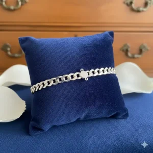 A high-quality sterling silver chain bracelet displayed on a velvet jewelry cushion.