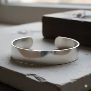 Close-up detail of a hand-polished sterling silver minimalist cuff bracelet.