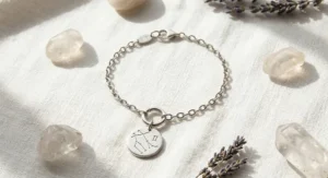 Minimalist silver Gemini constellation charm bracelet with engraved stars and twin symbols.