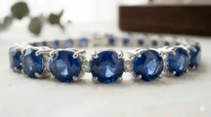 Close-up view of a blue sapphire tennis bracelet showing the four-prong setting and stone clarity.