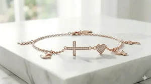 A trendy rose gold cross charm bracelet featuring a small heart detail for a feminine touch.