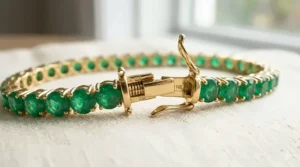 Detailed view of the double-safety tongue clasp on a handcrafted emerald tennis bracelet.