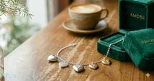 Fashionable layered look featuring multiple heart charm bracelets on a woman’s wrist.