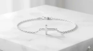 A delicate sterling silver cross charm bracelet with a polished finish on a white background.