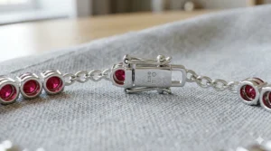 Close-up detail of a secure box clasp and safety latch on a sterling silver ruby tennis bracelet.