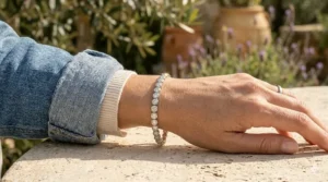 A bezel set diamond tennis bracelet styled with a denim jacket for a modern, casual look.