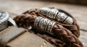 Close-up detail of hand-carved 925 sterling silver beads woven into a genuine brown leather bracelet.