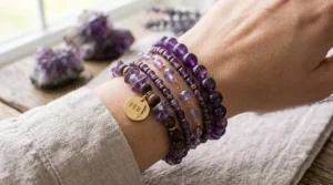 A stack of casual beaded amethyst birthstone bracelets featuring natural purple crystal