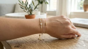 Close-up of a delicate silver minimalist slider chain bracelet worn on a woman's wrist.