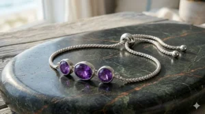 Sterling silver adjustable bolo bracelet featuring a row of alternating colorful multi-gemstones including amethyst, blue topaz, and citrine.