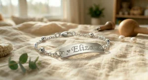 Elegant gift wrapping and a velvet pouch enclosing a custom sterling silver baby name bracelet.