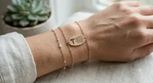 Close-up illustration of a sleek rose gold ID tag showing the classic medical caduceus symbol on a dainty chain.