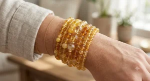A stack of natural citrine quartz beaded bracelets with warm yellow and orange gemstone beads, styled for everyday wear.