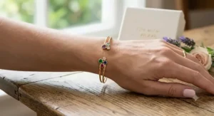 Elegant adjustable cuff bracelet with family birthstones on the tips, styled as a Mother's Day jewelry gift.