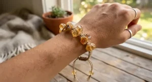 A handmade bohemian style bracelet crafted with rough, unpolished natural citrine crystal nuggets on an adjustable cord.