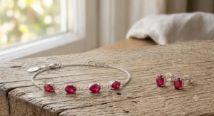 Minimalist sterling silver chain bracelet featuring a single baguette cut July birthstone ruby gem.