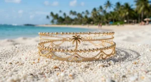 Waterproof gold beach anklet for women resting on white sand.
