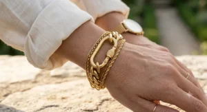 Women's gold-plated stainless steel carabiner bracelet layered with fine chain links