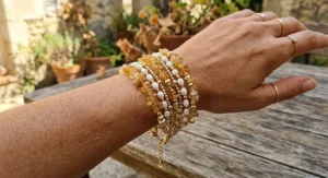 A statement multi-strand bracelet combining genuine citrine chips, freshwater pearls, and gold-filled accent beads.