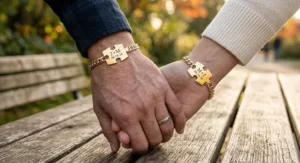Illustration of personalized gold matching puzzle bracelets for couples showing custom engraved initials on connected puzzle charms.